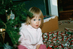Hiding behind the Christmas tree