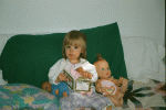 Reading to her dolls