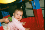 Hilde playing in her exersaucer