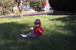 Hilde in the grass eating an apple