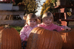 Maeve and Hilde posing by the pumpkins