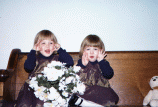 Playing on the church pew dressed in jumpers that Mom made